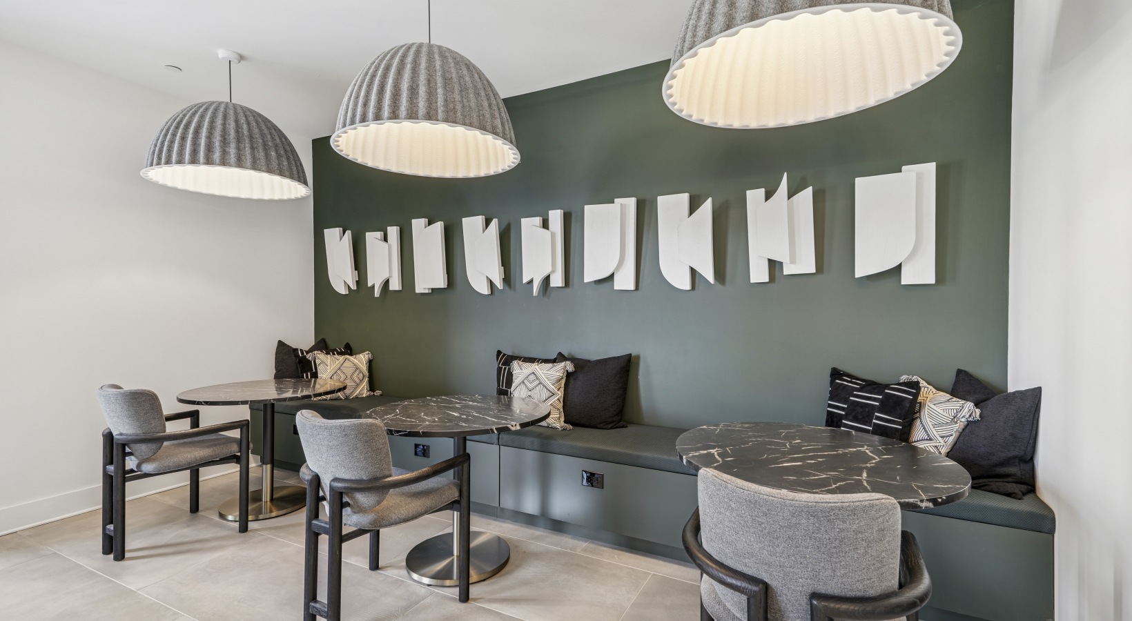 A coffee area with a green tiled wall.