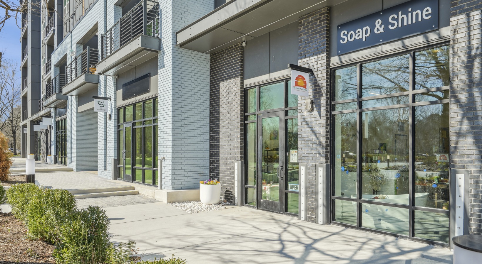 A grass and seating area outside an apartment building.