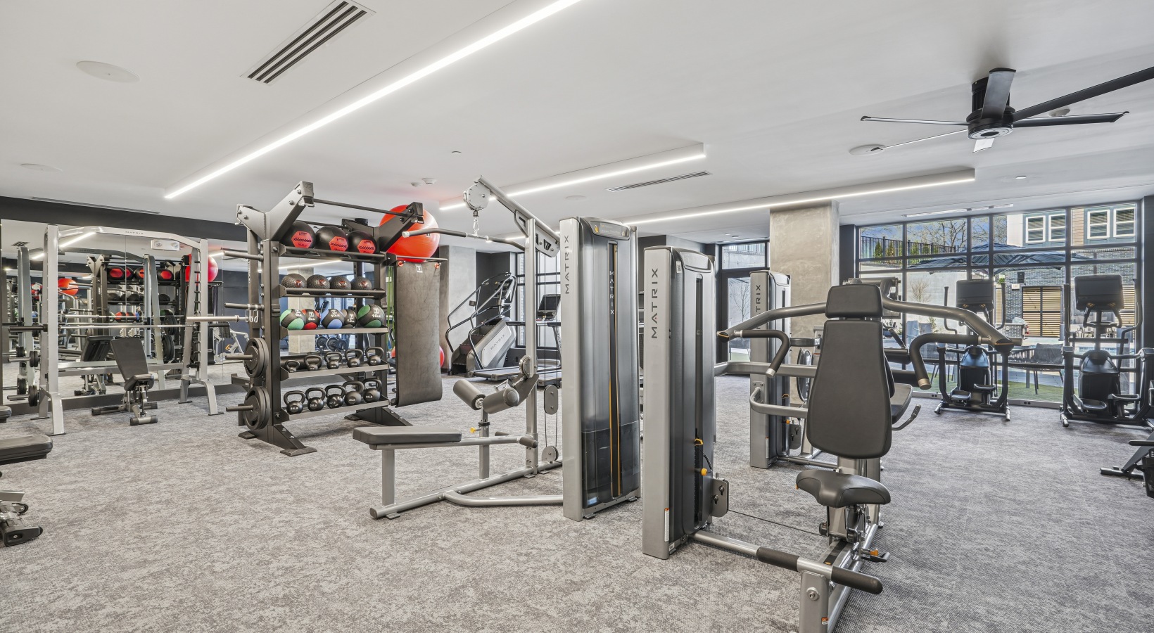 A room with a desk and chair with a patterned wallpaper.
