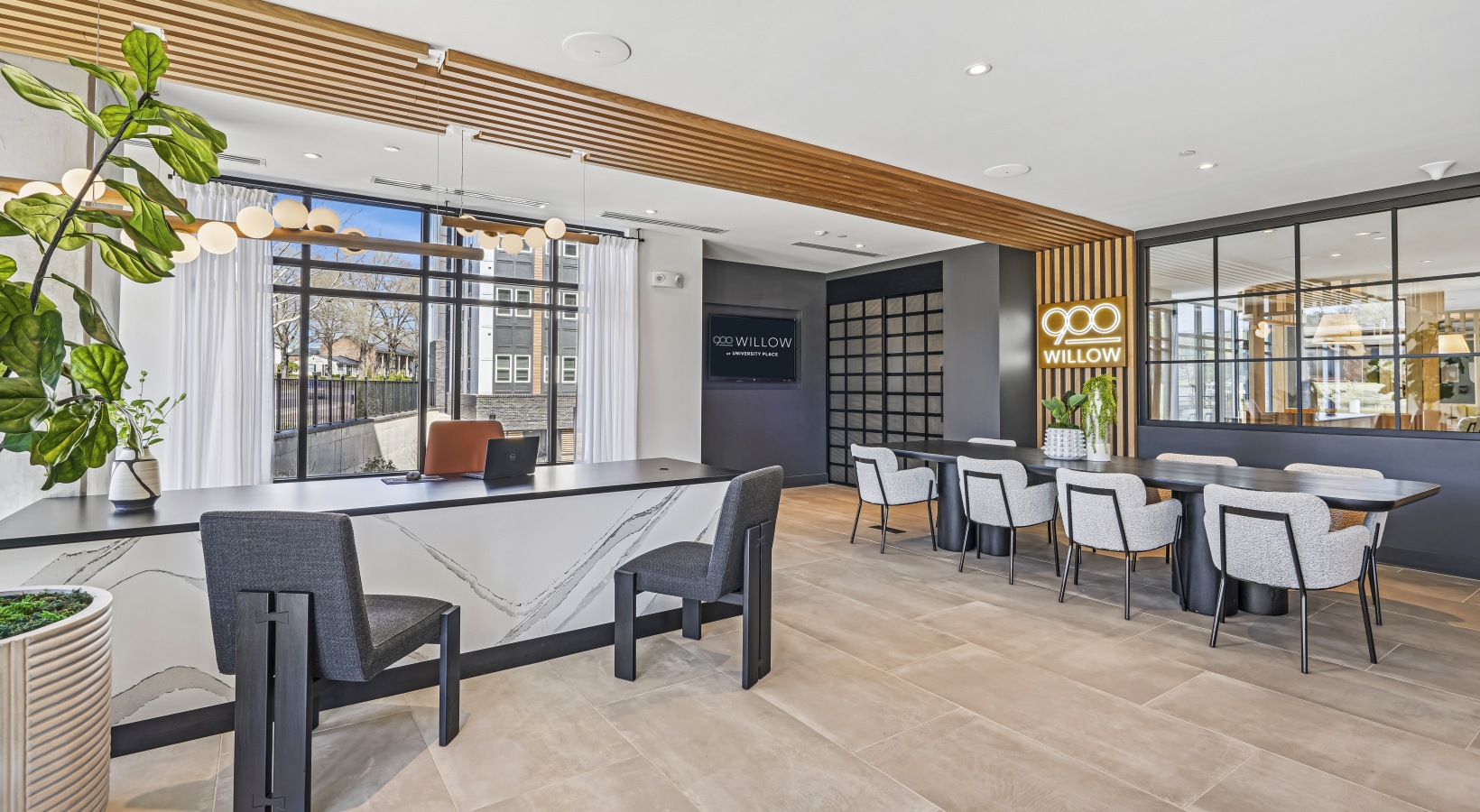 Leasing office with white table and black chairs.