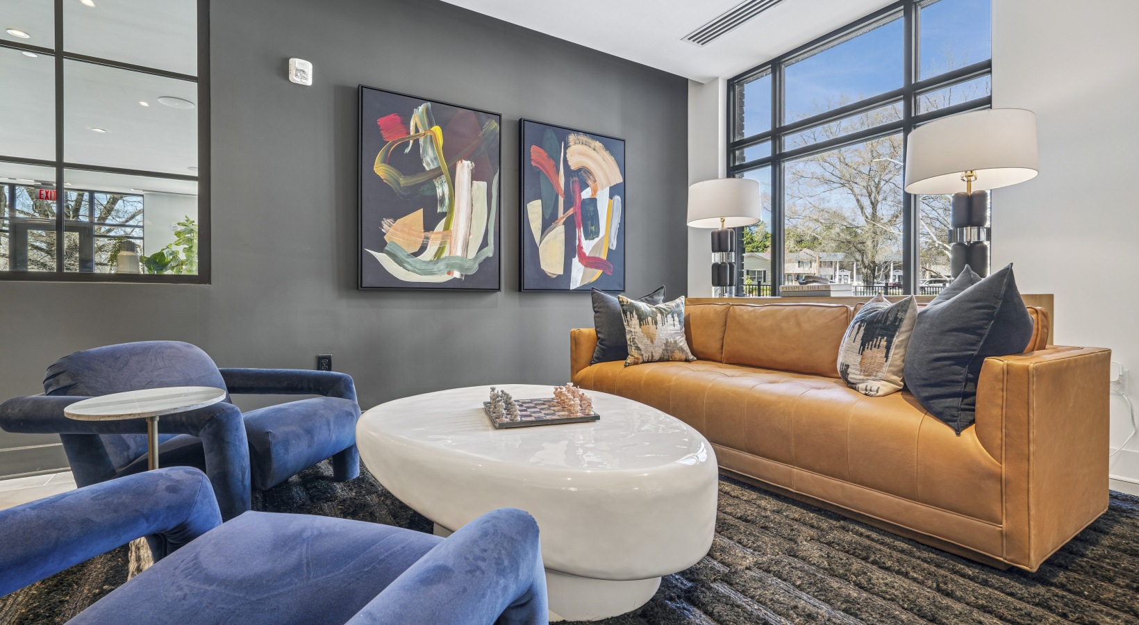 A modern kitchen island with four white stools.