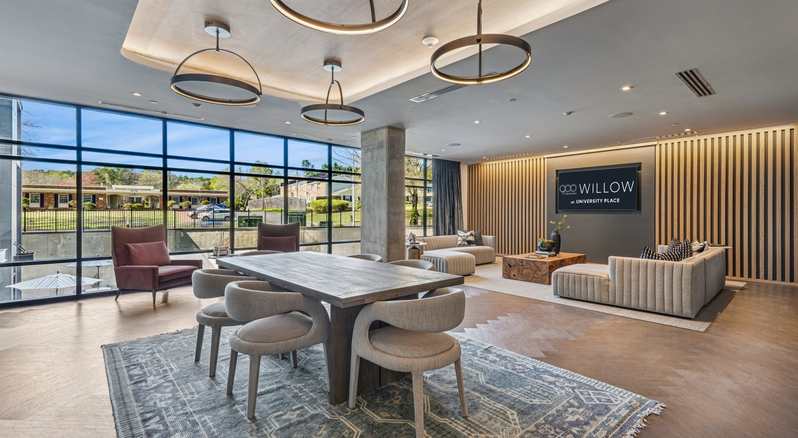 Leasing office with white table and black chairs.
