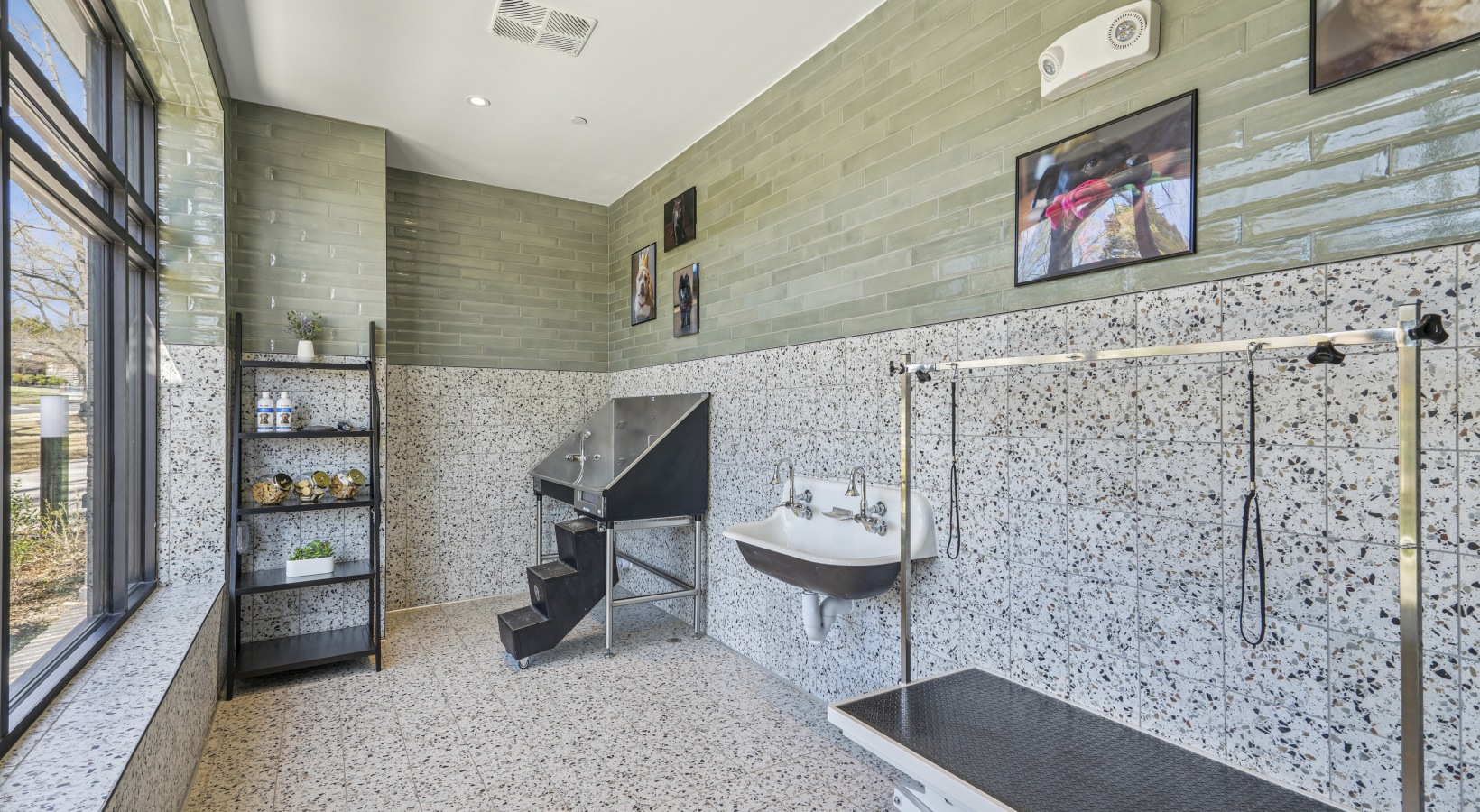 A mail room with green walls and white mailboxes.